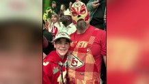 Elijah Smith poses for a photo with Jason Kelce wearing a Luchador mask at a party celebrating the Kansas City Chiefs Super Bowl win.