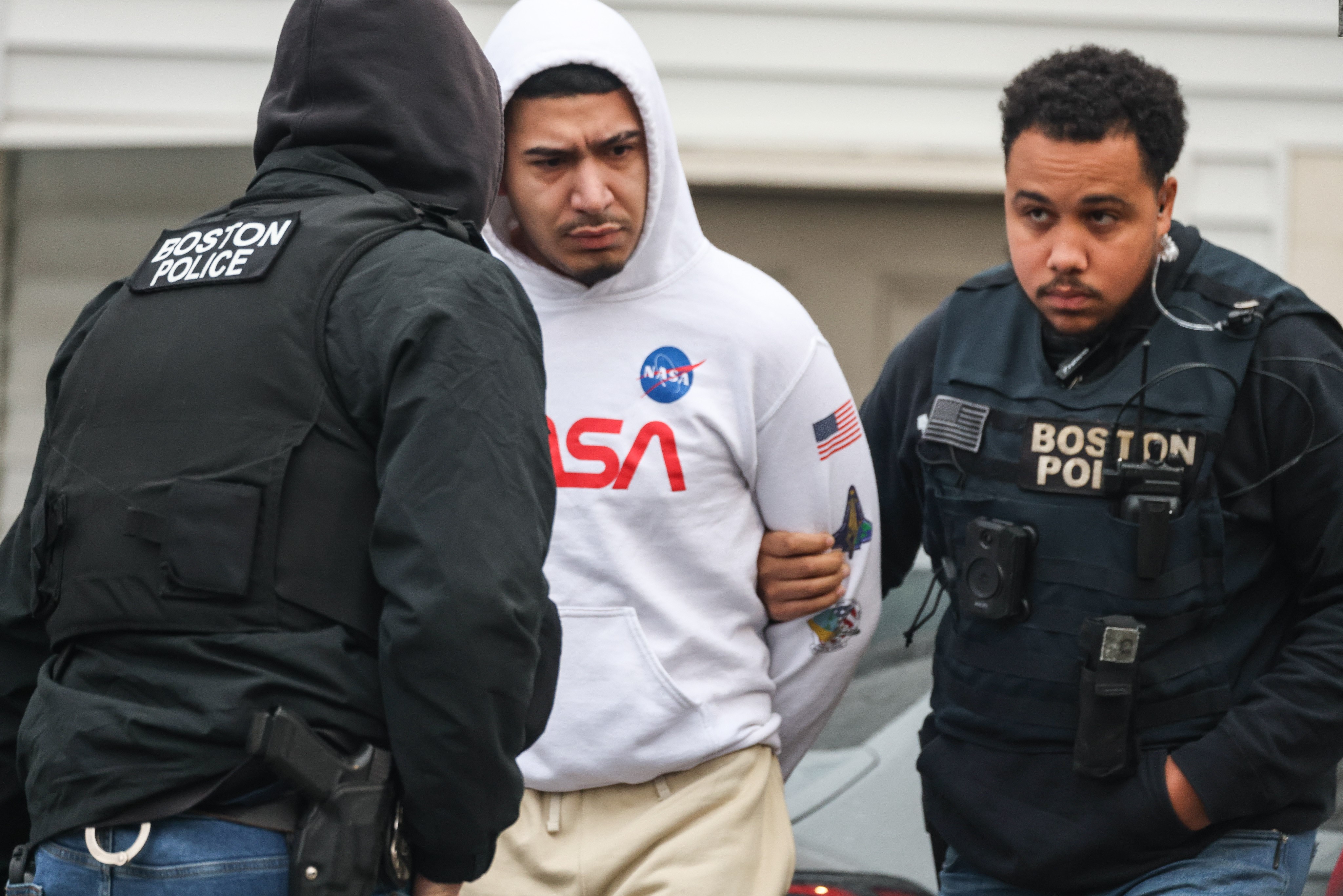 A man being taken into Boston police custody in Chelsea on Friday, Feb. 23, 2024.