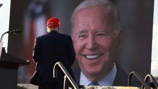 Former U.S. President Donald Trump watches a video of President Joe Biden playing during a rally for Sen. Marco Rubio (R-FL) at the Miami-Dade Country Fair and Exposition on November 6, 2022 in Miami, Florida.