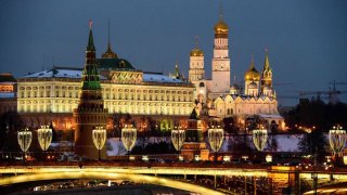 A photograph taken on March 12, 2018 shows the Kremlin complex (Rear) and the Bolshoy Kamenny bridge crossing the river Moskva in Moscow. 