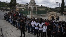 Palestinian Muslim worshipers who were prevented from entering the Al-Aqsa Mosque compound, pray outside Jerusalem's Old City, Friday, March 8, 2024. Restrictions put in place amid the Israel-Hamas war have left many Palestinians concerned they might not be able to pray at the mosque, which is revered by Muslims. (AP Photo/Mahmoud Illean)