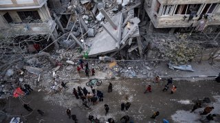 Palestinians inspect the damage of residential buildings after an Israeli airstrike in Rafah, southern Gaza Strip, Sunday, March 24, 2024. (AP Photo/Fatima Shbair)