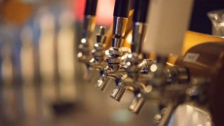 Cold beer on tap in a pub at night
