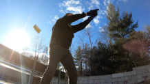 This is an image of Boston ATF Special Agent Matthew O'Shaughnessy shooting a gun.