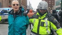 A police officer makes an arrest during a pro-Palestinian demonstration that disrupted traffic outside Boston's South Station on Thursday, March 7, 2024.