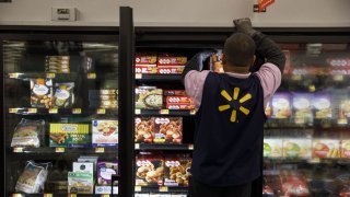 An employee restocks frozen food products at a Walmart Inc. store in Burbank, California.