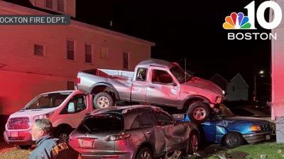 Pick-up truck crashes, lands on cars in Brockton