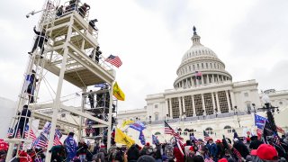 People gather in front of the U.S. Capitol building.