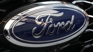 FILE - The Ford logo is seen on the grill of a Ford Explorer on display at the Pittsburgh International Auto Show in Pittsburgh, on Feb. 15, 2024. Two fatal crashes involving Ford’s Blue Cruise partially automated driving system have drawn the attention of U.S. auto safety regulators.