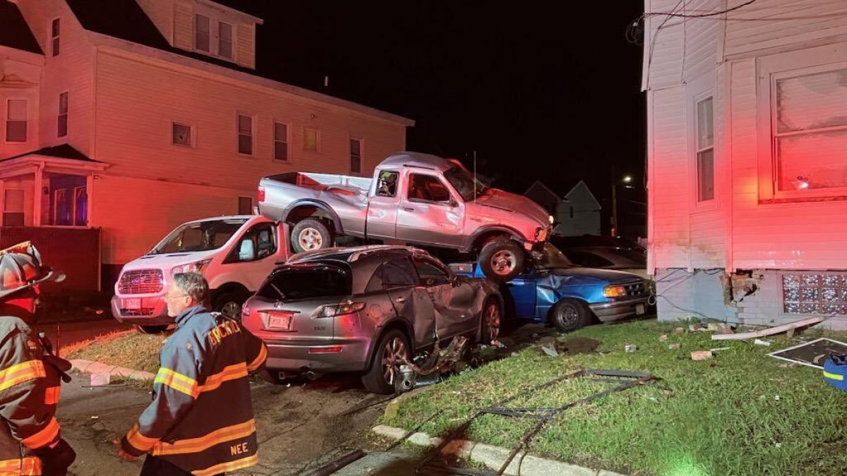 Pickup truck crashes into home, lands on top of cars in Brockton; driver flees – NBC Boston