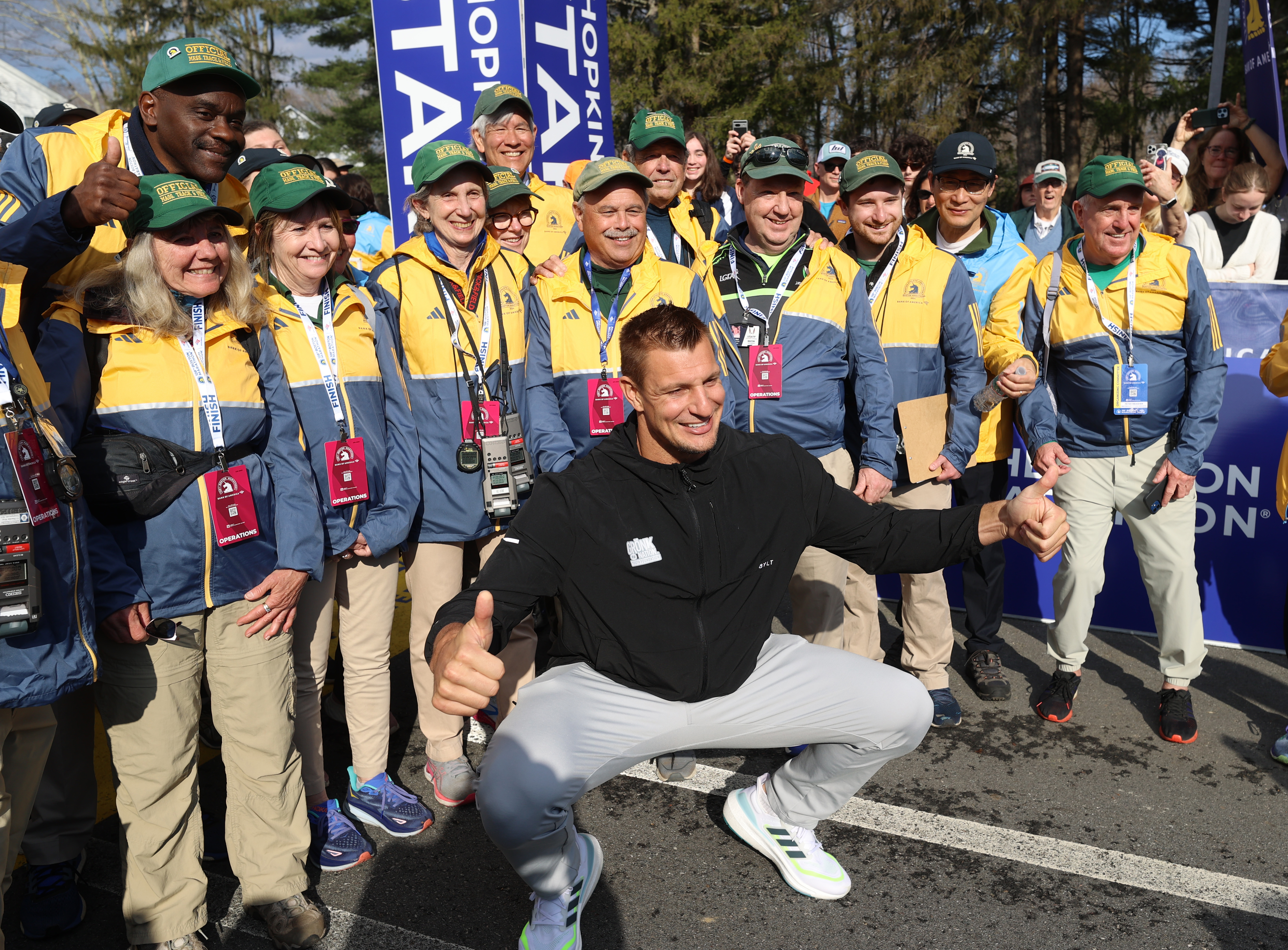 Rob Gronkowski poses with volunteers at the Boston Marathon starting line.