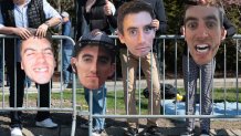 Family members hold cut outs of Boston Marathon runner Alex Gornick on Heartbreak Hill in Newton, Massachusetts, during the Boston Marathon.