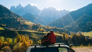 Couple admires mountain range.