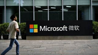 A man walks past Microsoft’s local headquarters in Beijing on July 20, 2021. 