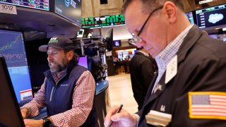 Traders work on the floor of the New York Stock exchange during morning trading on May 17, 2024.