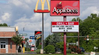 Signs for restaurants including Applebee’s, McDonald’s, Pizza Hut, and Burger King are seen along U.S Route 11 in Bloomsburg, Pennsylvania.