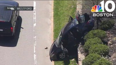 Car crashes over wall in Westford