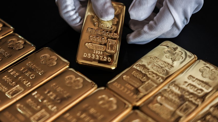 An employee handles one kilogram gold bullion at the YLG Bullion International Co. headquarters in Bangkok, Thailand, on Friday, Dec. 22, 2023. Gold headed for a weekly gain after US price data came in cooler than forecast, reinforcing expectations for multiple interest rate cuts by the Federal Reserve next year. Photographer: Chalinee Thirasupa/Bloomberg via Getty Images