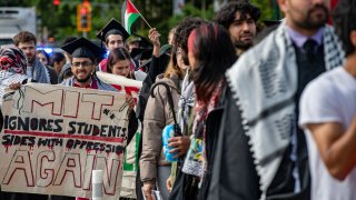 Pro-Palestinian students march over the Massachusetts Avenue bridge after walking out during the OneMIT Commencement Ceremony at the Massachusetts Institute of Technology (MIT) in Cambridge, Massachusetts on May 30, 2024. (Photo by Joseph Prezioso / AFP) (Photo by JOSEPH PREZIOSO/AFP via Getty Images)