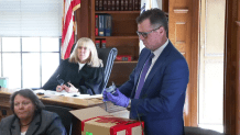 Canton Police Lt. Michael Lank holds a broken glass, evidence in the Karen Read murder trial, in Norfolk Superior Court on Tuesday, May 7, 2023.