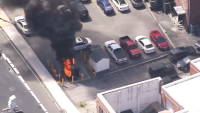 Heavy smoke, flames seen pouring from street in Lowell: Watch live