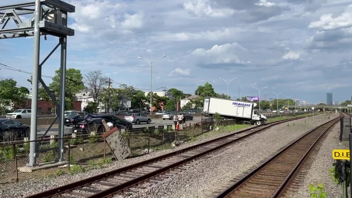 Mass. Pike crash leaves truck beside MBTA commuter train tracks in Allston – NBC Boston