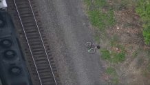 A bicycle near an MBTA Commuter Rail train in Natick on Monday, May 13, 2024. Two people were killed by the train.