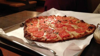 A pizza pie at a location of Sally's Apizza