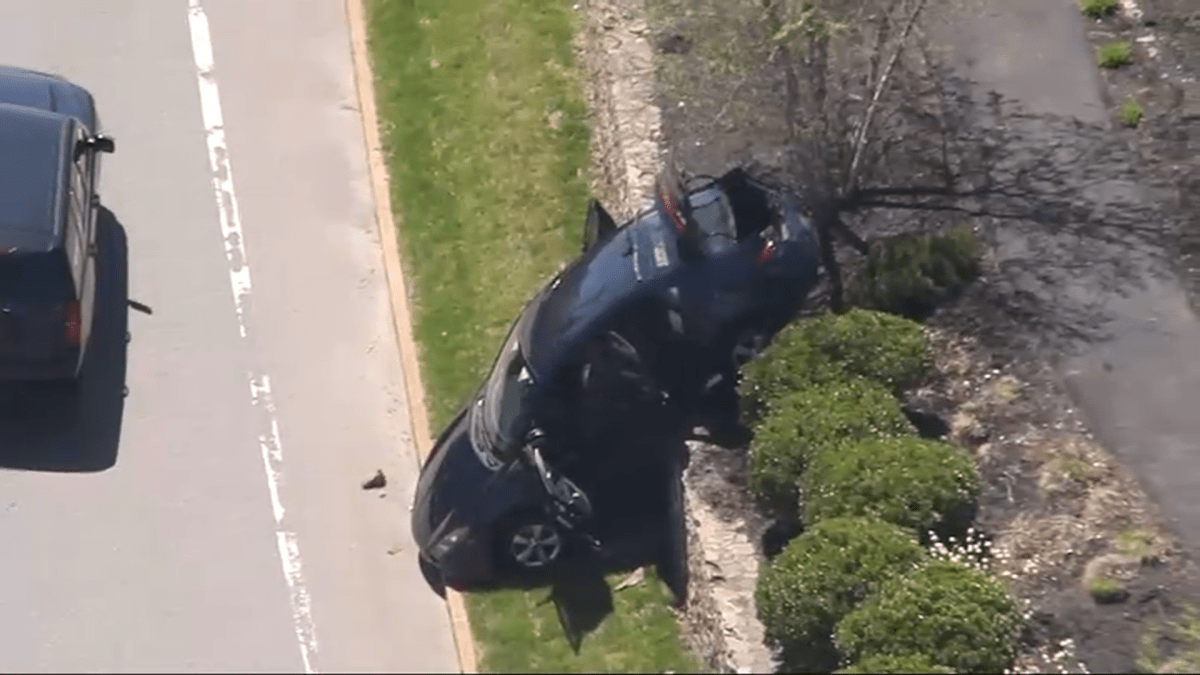 Car crashes over wall at Westford shopping center; driver hurt