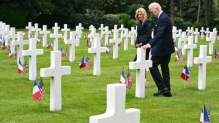 U.S. President Joe Biden and U.S. First Lady Jill Biden walk amid the graves at the Normandy American Cemetery and Memorial after the U.S. ceremony marking the 80th anniversary of the World War II “D-Day” Allied landings in Normandy, in Colleville-sur-Mer, which overlooks Omaha Beach in northwestern France, on June 6.