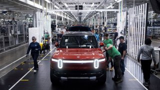 Workers assemble second-generation R1 vehicles at electric automaker Rivian’s manufacturing facility in Normal, Illinois, on June 21, 2024.