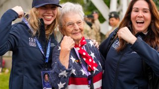 Anna Mae Krier, also known as a Rosie the Riveter, center, poses during a service at the Pegasus Bridge memorial in Benouville, Normandy, France, Wednesday, June 5, 2024.