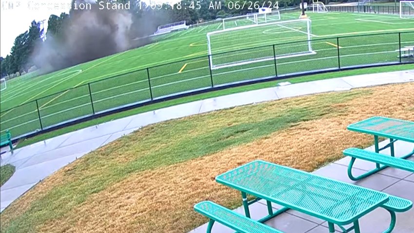 A sink hole opens up in an Illinois park, releasing a huge plume into the air