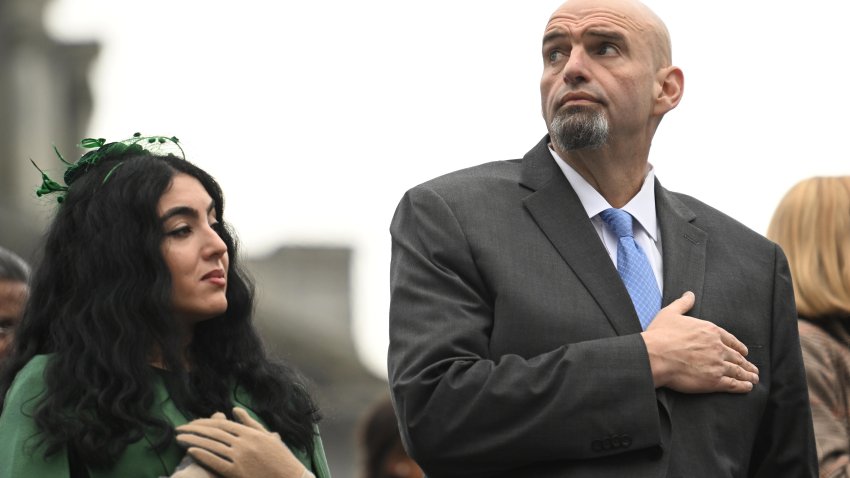 Sen. John Fetterman (D-PA) and his wife, Gisele Barreto Fetterman with hands on hearts during National Anthem.