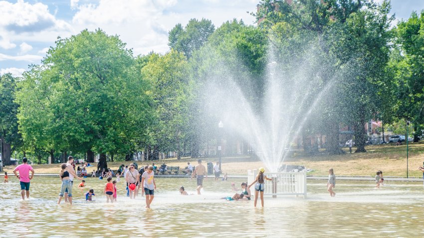 Boston Common Frog Pond crowded with people during heatwave on a summer day