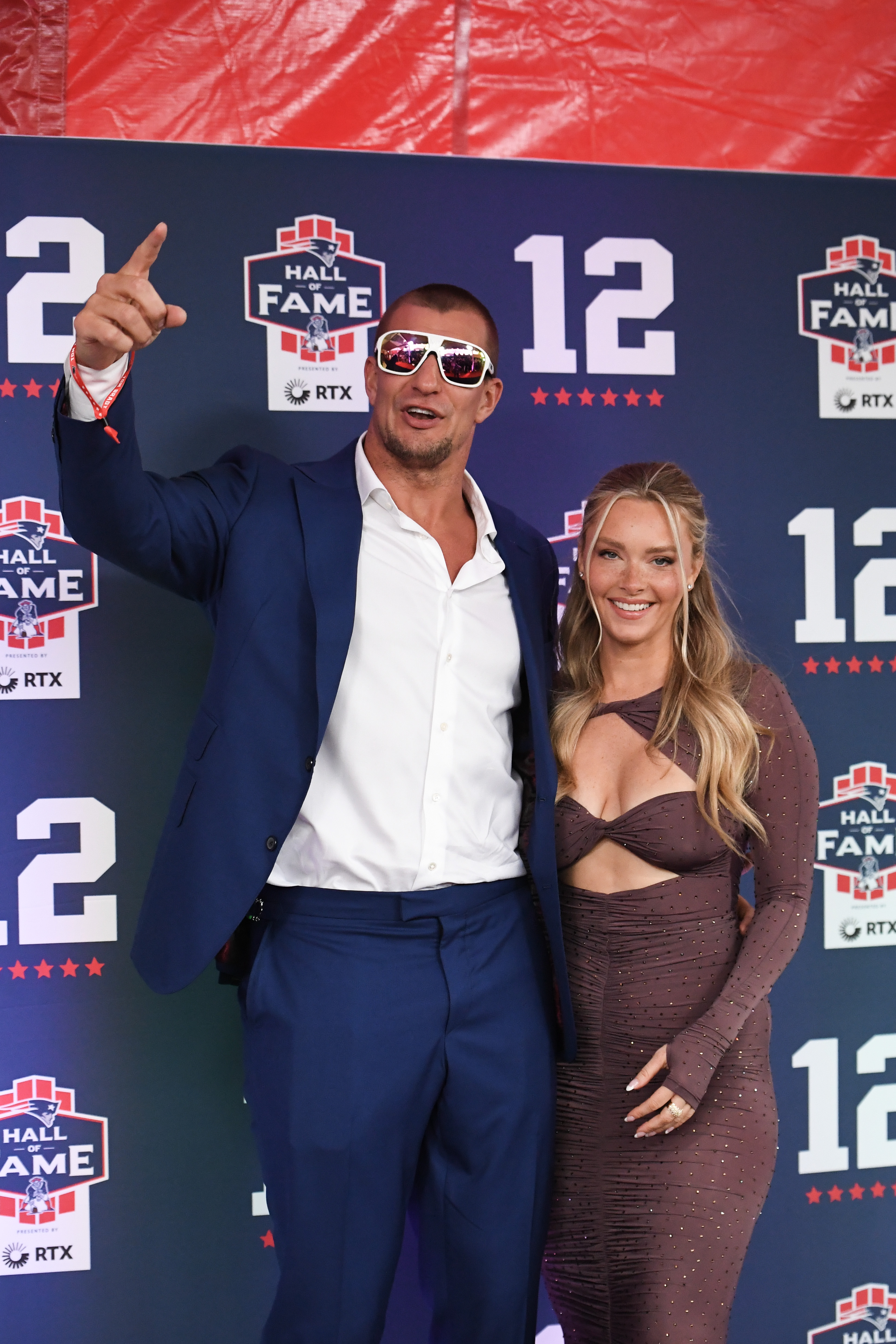 Rob Gronkowski and Camille Kostek pose for a photo on the carpet prior to the 2024 Hall of Fame Induction Ceremony for Tom Brady at Gillette Stadium on June 12, 2024 in Foxborough, Massachusetts.