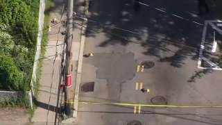 Evidence markers placed at the sight of a stabbing investigation in Boston’s Hyde Park neighborhood Monday.