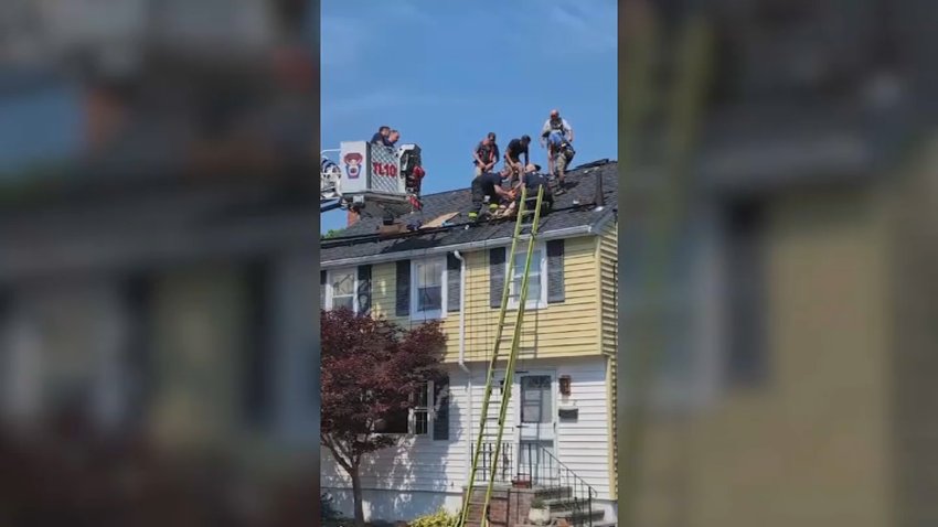 A worker had to be rescued from the roof of a home in Roslindale on Wednesday, during extreme heat.