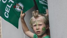A young Boston Celtics fan holds a sign ahead of the championship duck boat parade Friday, Jun 21, 2024.