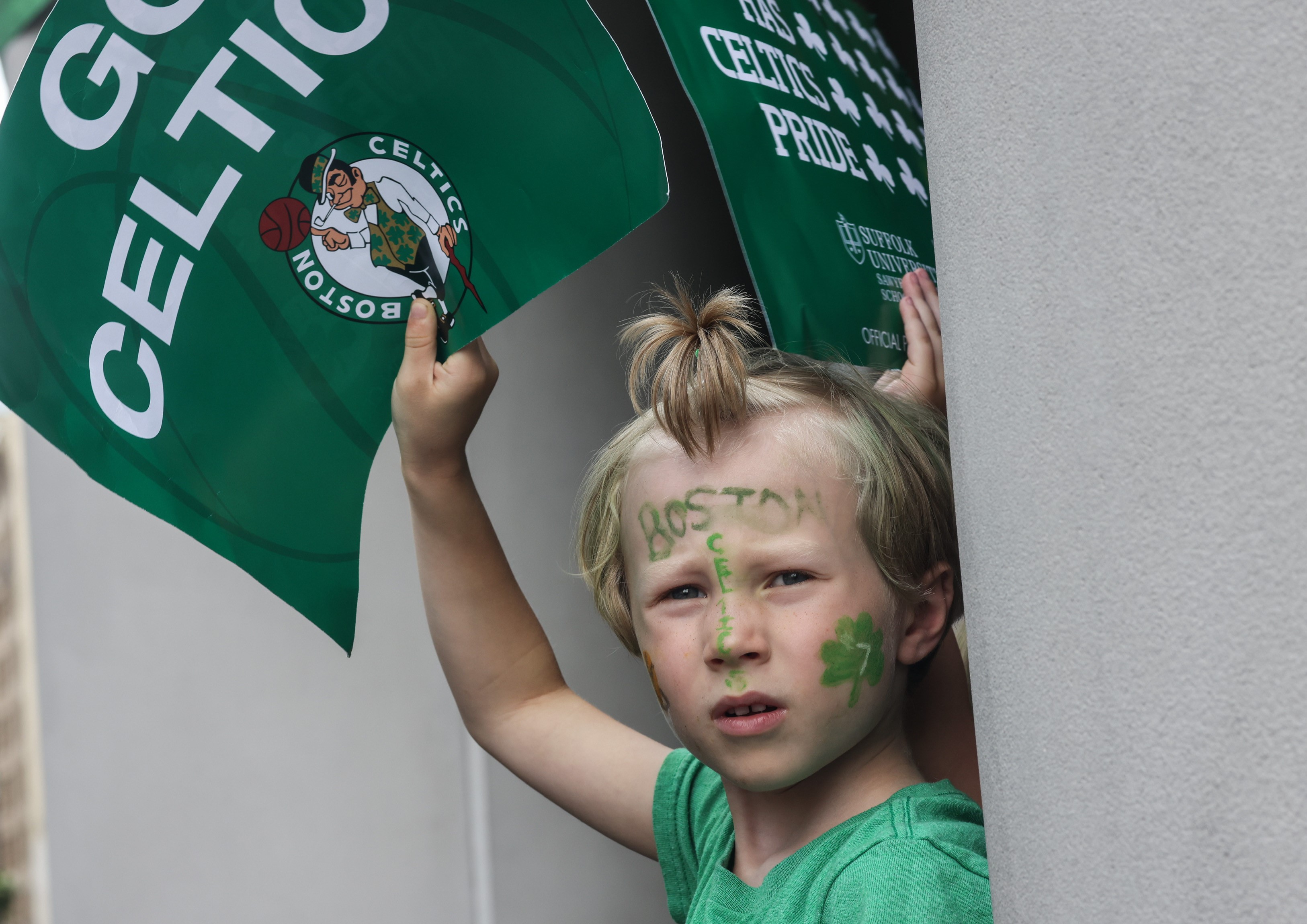 A young Boston Celtics fan holds a sign ahead of the championship duck boat parade Friday, Jun 21, 2024.