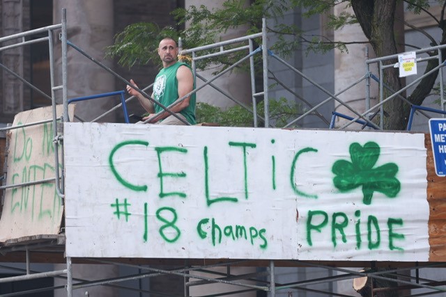 A sign on scaffolding in Boston for the Celtics' championship parade that reads "CELTIC ☘️ #18 Champs PRIDE"