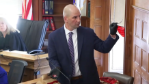 Massachusetts State Police investigator Michael Proctor holding a broken piece of a taillight in Norfolk Superior Court during the murder trial of Karen Read on Monday, June 10, 2024.