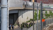 A broken fence above a fiery car wreck in Boston on Wednesday, June 5, 2024.