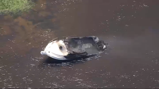 A charred boat in the Merrimack River off Newburyport, Massachusetts, after a fire on Monday, June 3, 2024.