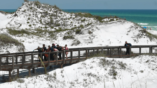 Medics carry a shark attack victim to safety in Watersound, Walton County, Fla.