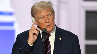 TOPSHOT – Former US president and Republican presidential candidate Donald Trump touches his injured ear during a sound check on the third day of the 2024 Republican National Convention at the Fiserv Forum in Milwaukee, Wisconsin, on July 17, 2024. 