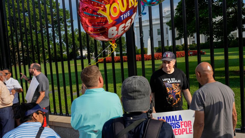 Paople gathered, Sunday July 21, 2024, outside the White House in Washington.