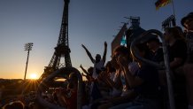 Spectators cheer in the men's pool B beach volleyball match between Norway and Chile during the Paris 2024 Olympic Games at the Eiffel Tower Stadium in Paris on July 28, 2024. (Photo by Luis TATO / AFP) (Photo by LUIS TATO/AFP via Getty Images)