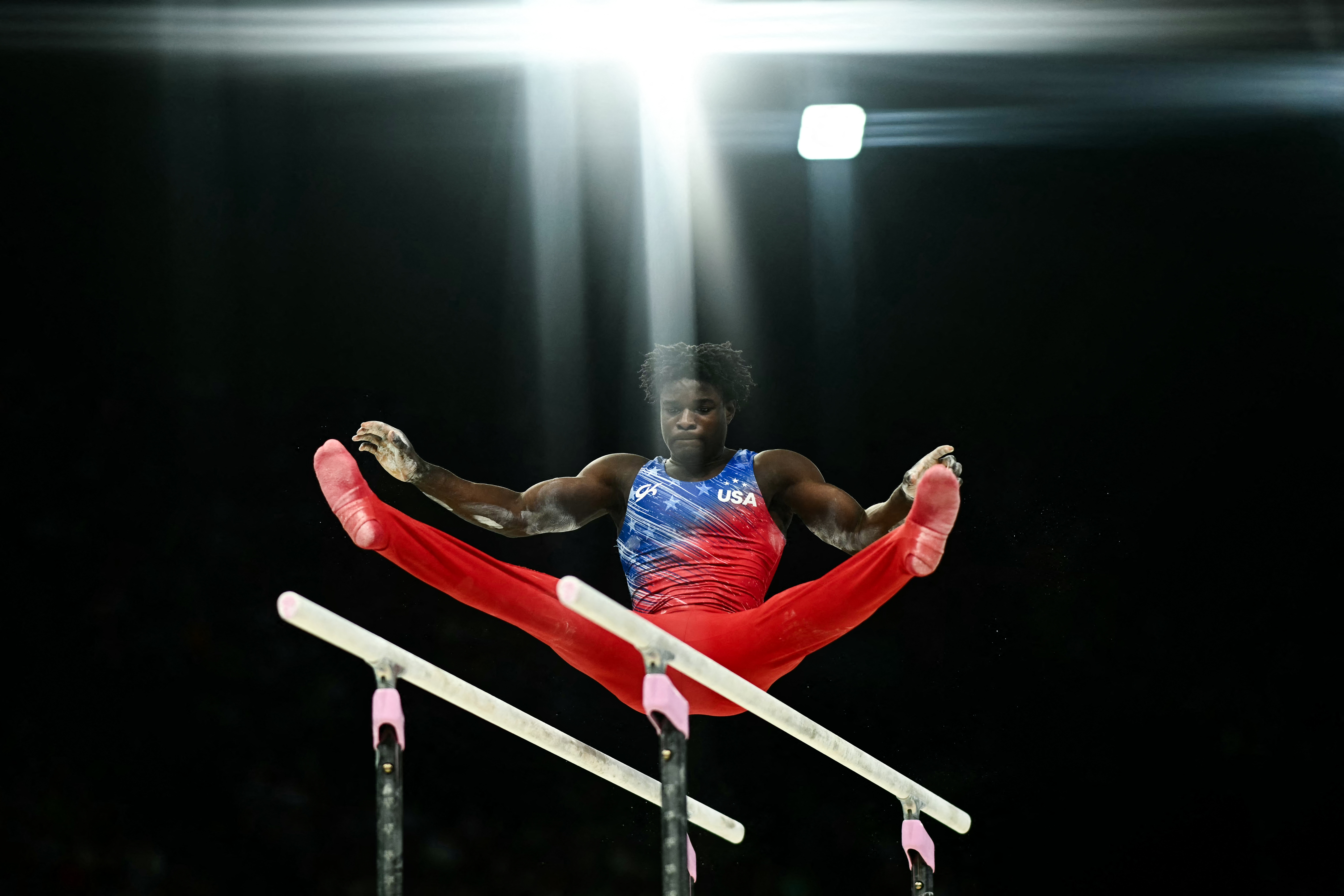 Frederick Richard, of Stoughton Massachusetts, competes in the parallel bars event of the artistic gymnastics men's all-around final at the Bercy Arena on Wednesday, July 31, 2024, during the Paris 2024 Olympic Games. (Photo by Loic VENANCE / AFP) (Photo by LOIC VENANCE/AFP via Getty Images)