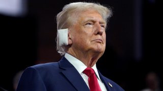 Former President Donald Trump sports a bandage over his ear, injured over the weekend in an assassination attempt at a campaign rally, at the Republican National Convention in Milwaukee on Monday, July 15, 2024.